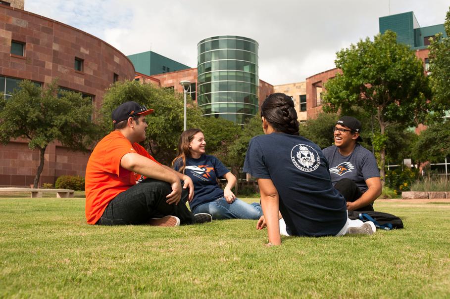 students sitting in the grass